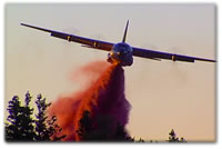 A Forest Service C130 makes a retardent drop as captured by a Sight & Sound Services camera.